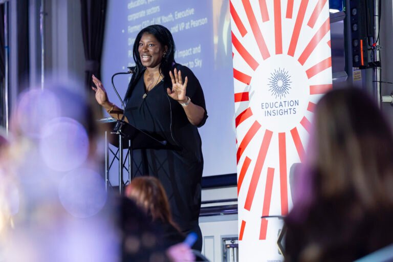 Speaker presenting at Education Insights event.