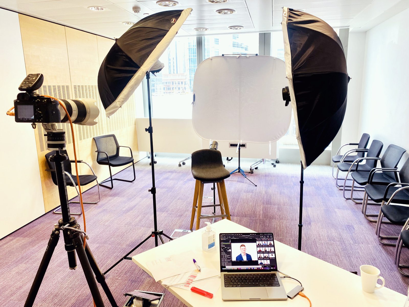 Portable headshot lighting and backdrop set up in a London office meeting room