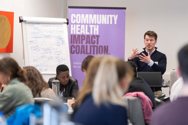 Person presenting at Community Health Impact event.