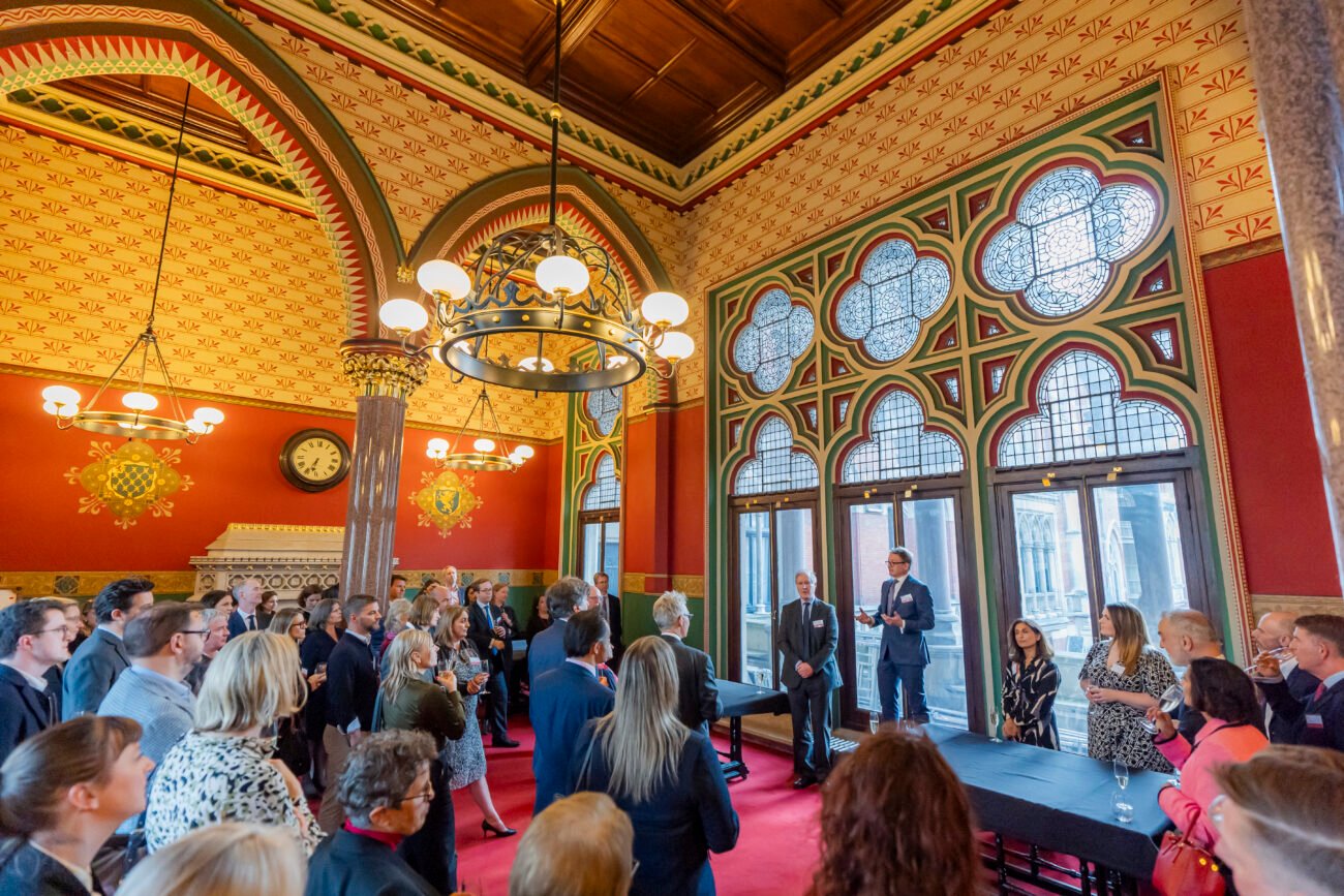 People at event in ornate historic building.