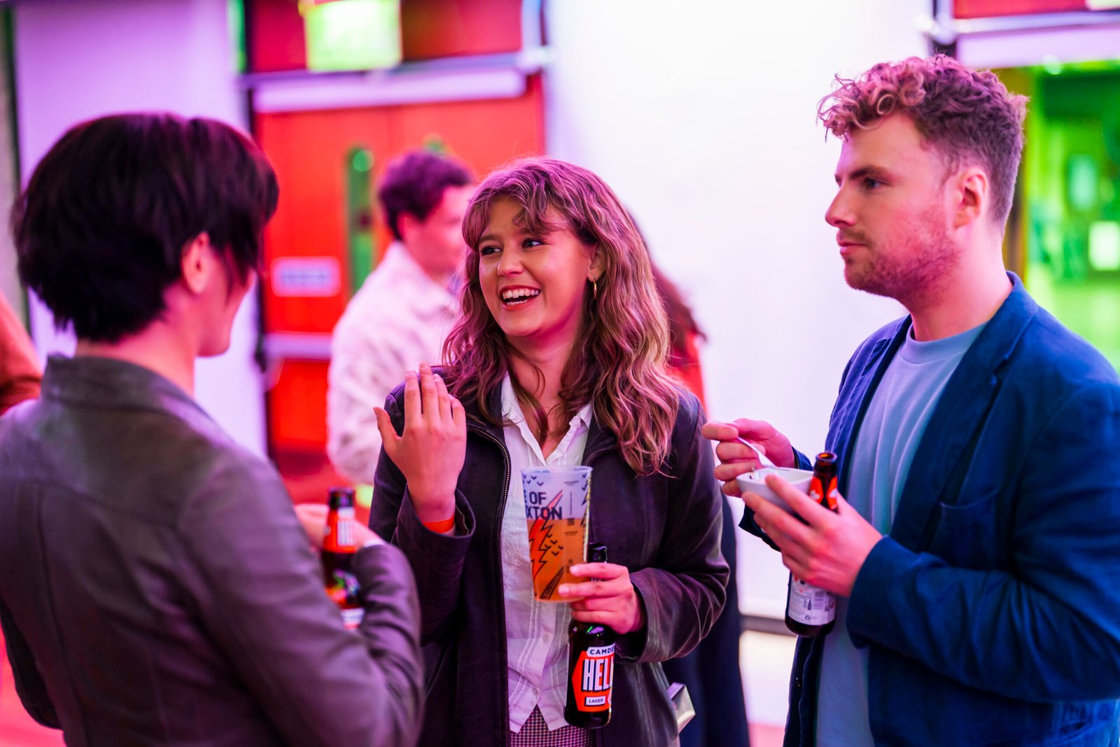 Group enjoying drinks and conversation at a party.