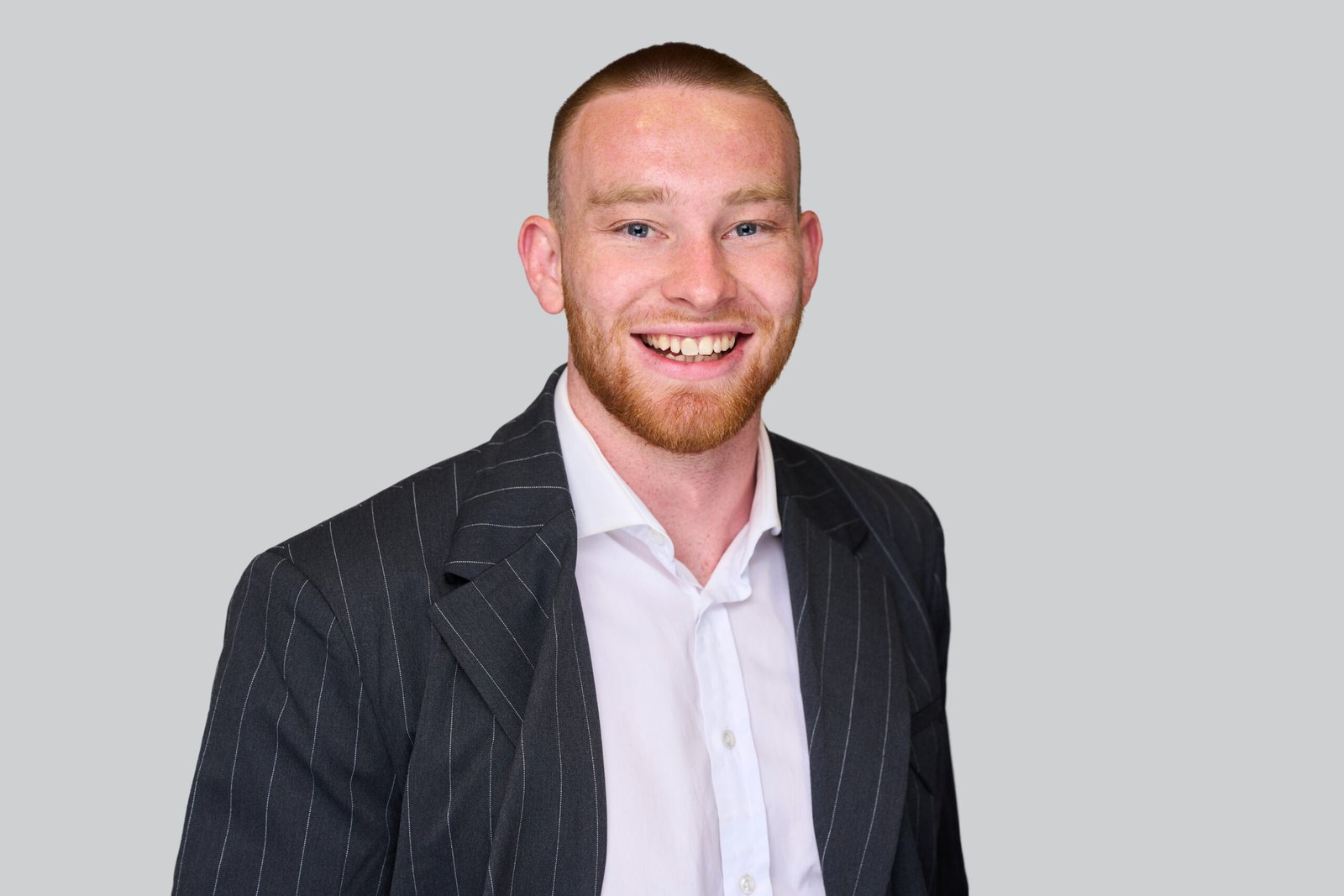 Smiling person in a suit portrait.