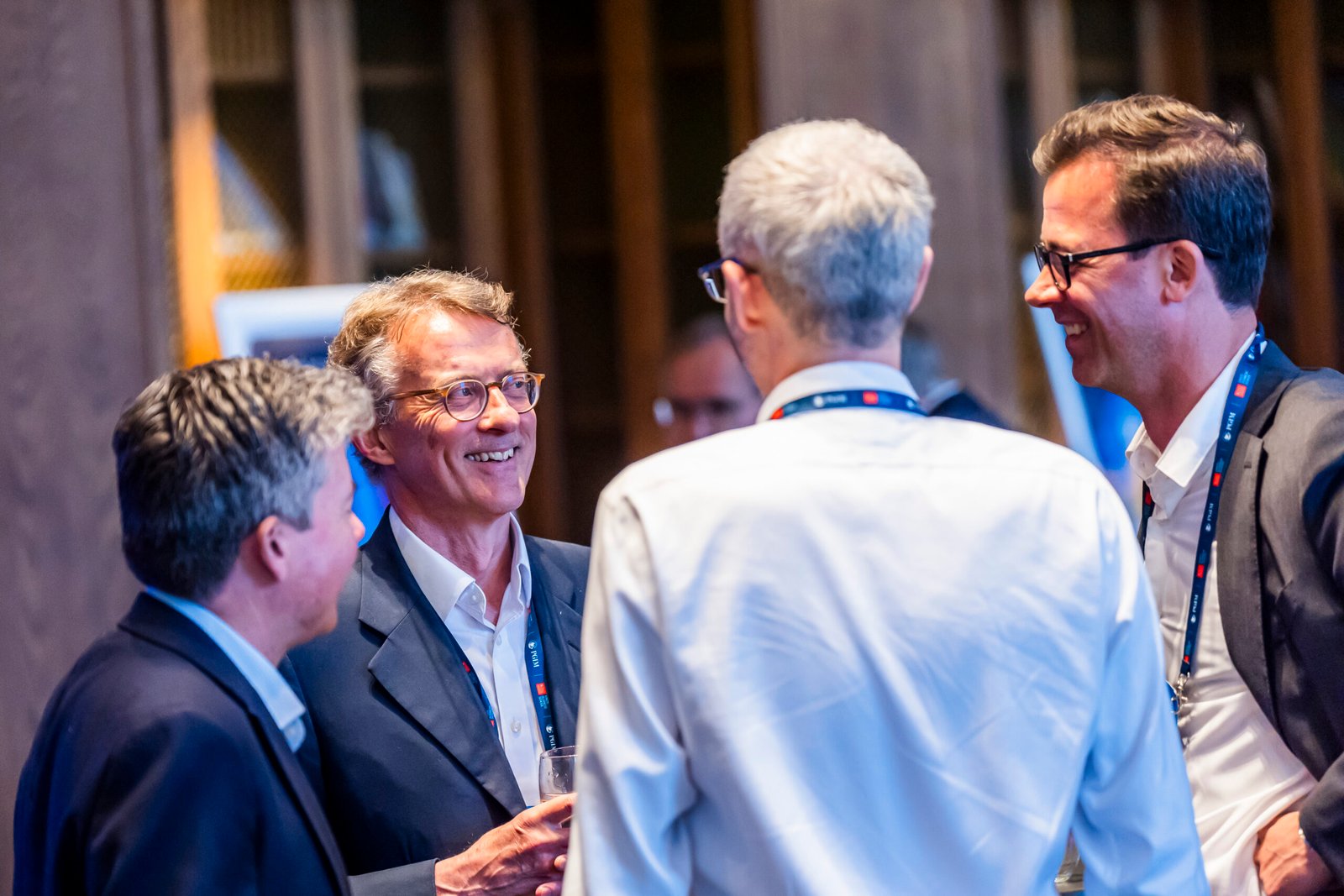 Group of professionals networking at event.