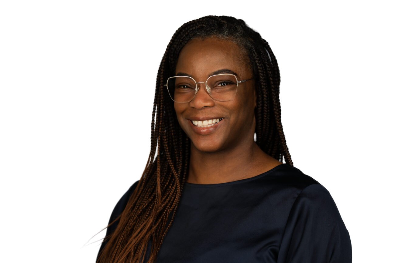 Smiling person with glasses and braids portrait
