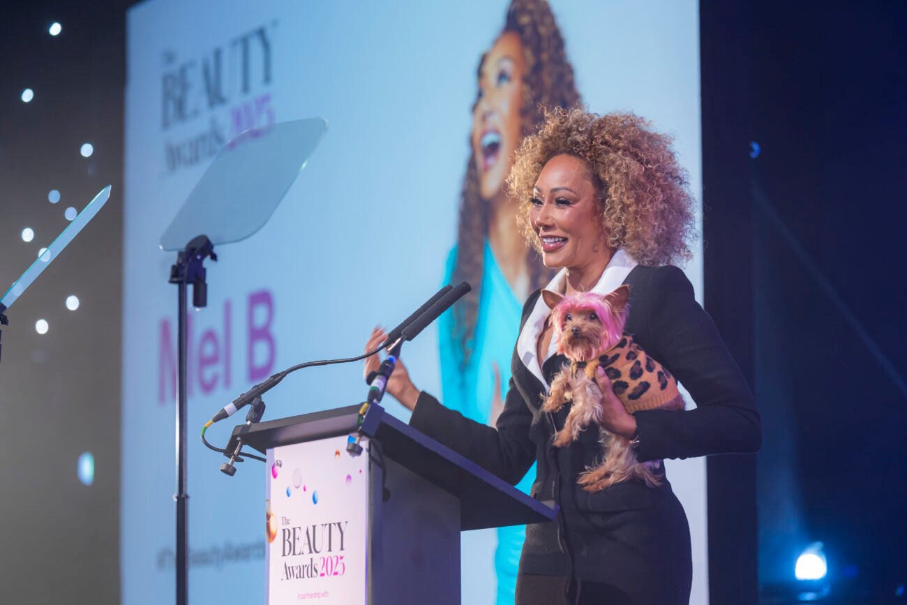 Person with dog at Beauty Awards 2025 event.