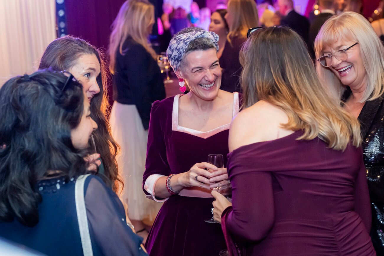 Women laughing at a social event