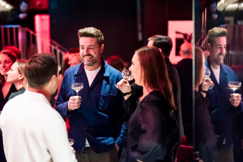 People socialising at a lively evening event.