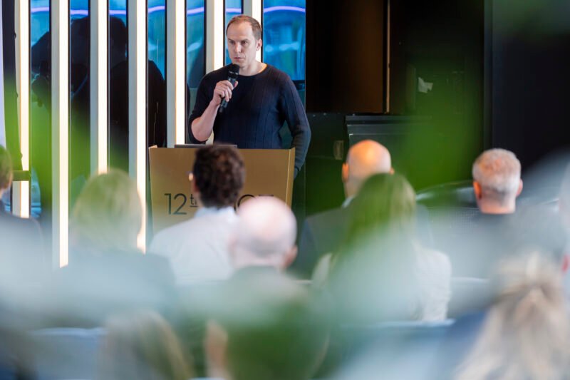 Speaker addressing audience at a conference