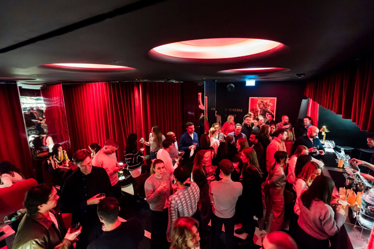 People socialising at a lively, dimly lit bar.