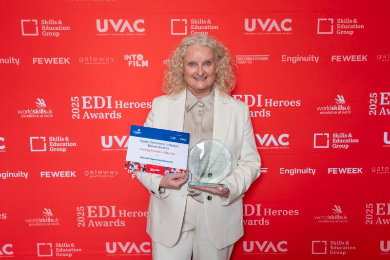 Person holding award at EDI Heroes Awards 2025.