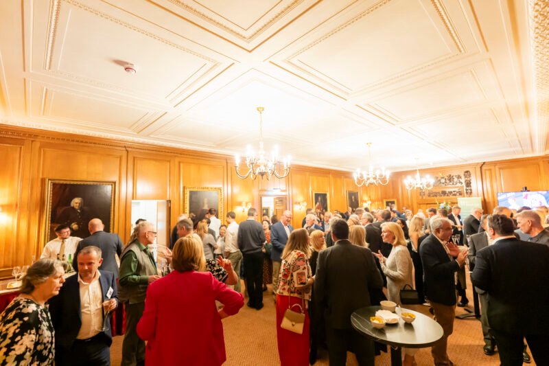 People networking at a corporate gala event indoors.