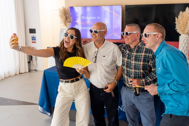 Group enjoys selfie at summer party event.