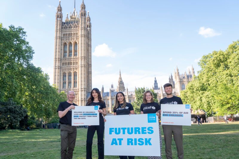 UNICEF rally outside UK Parliament highlighting children's aid cuts.