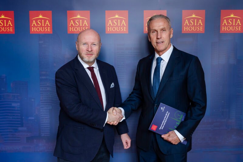 Two men shaking hands at Asia House event.
