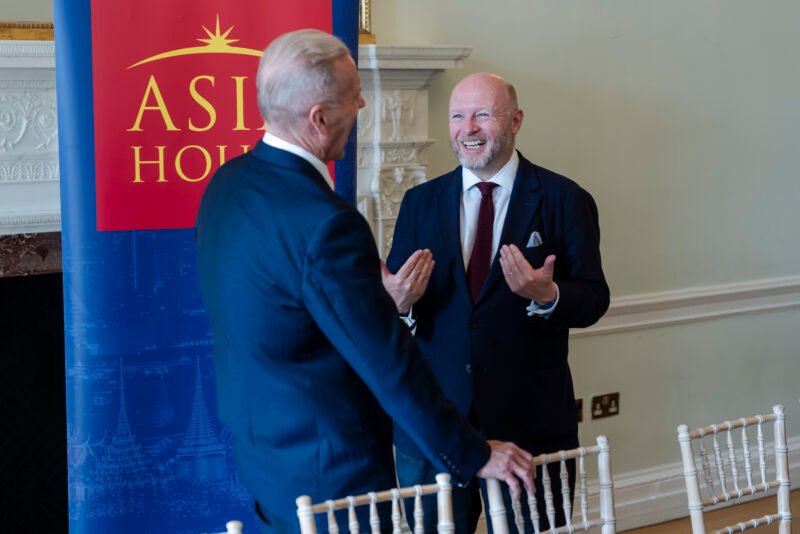 Two men discussing at Asia House event.