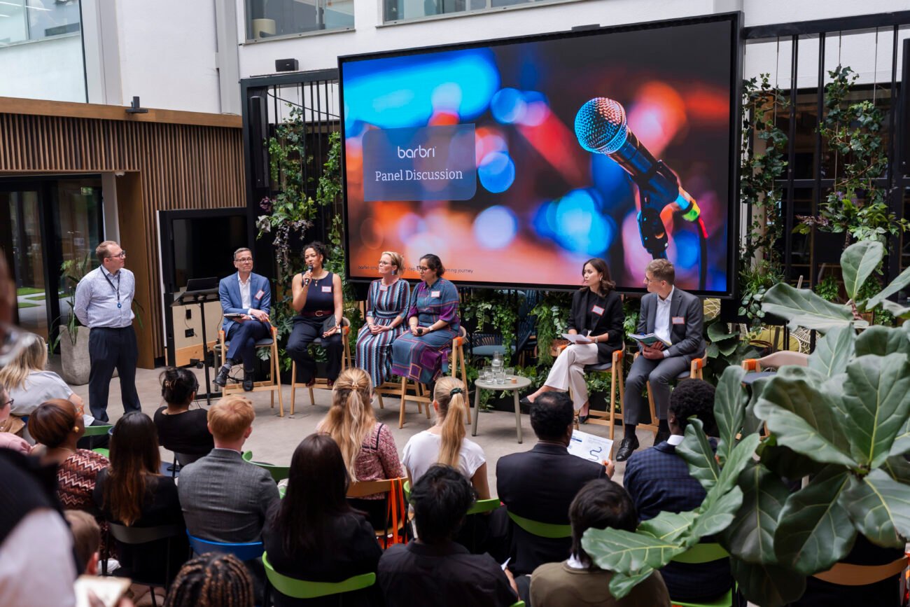 Diverse panel discussion in modern indoor venue.